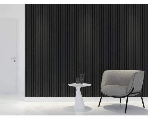 Wohnraum mit Akustikpaneelen an der Wand, einem Sessel und einem Beistelltisch.