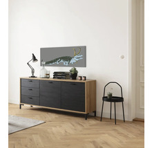 Wohnzimmer mit Sideboard, Tischleuchte, Deko-Objekten und Wandbild