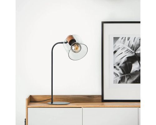 Lampe de table avec abat-jour en verre et ampoule sur un buffet