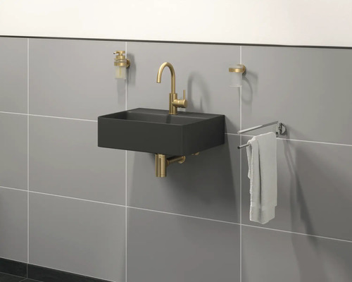 Modernes Badezimmer mit schwarzem Waschbecken, goldener Armatur und Handtuchhalter