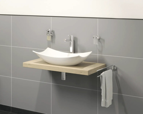 Meuble-lavabo avec vasque à poser, robinetterie et porte-serviettes dans la salle de bains