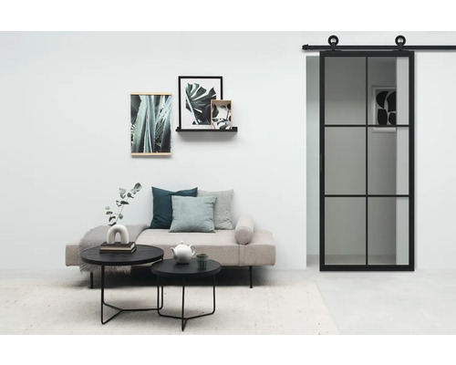 Wohnzimmer mit Schiebetür, Sofa, Couchtischen und Wanddekoration