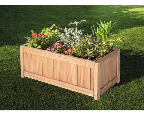 Holzpflanzkasten mit verschiedenen Pflanzen im Garten