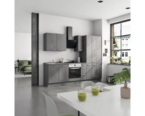 Cuisine claire et spacieuse avec kitchenette grise, hotte aspirante et table à manger blanche