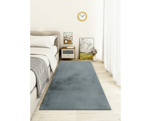 Chambre avec lit, table de chevet et tapis gris