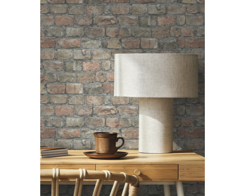 Pièce avec papier peint en briques, bureau et lampe