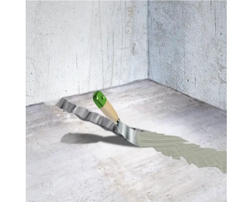 Réparation de fissures dans un sol en béton à l''aide d''une spatule