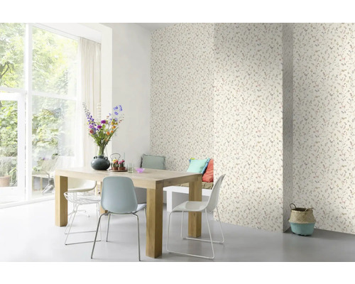 Salle à manger avec papier peint à motifs floraux, table en bois et chaises.