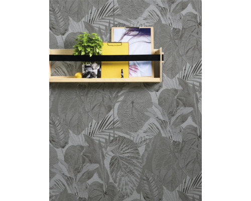 Fotografie einer Wand mit Blättertapete und einem Wandregal mit Dekoration