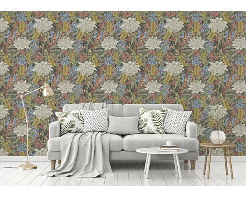 Wohnzimmer mit floral gemusterter Tapete und hellgrauem Sofa