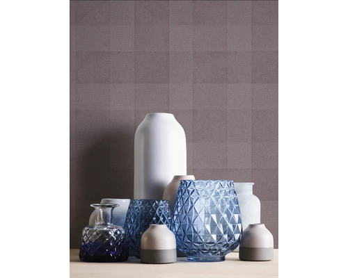 Verschiedene Vasen vor einer gemusterten Tapete