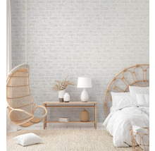 Helles Schlafzimmer mit Rattanmöbeln und Backsteinwand