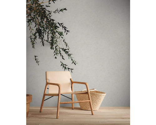 Scène avec fauteuil, panier et décoration sur plancher en bois devant un mur