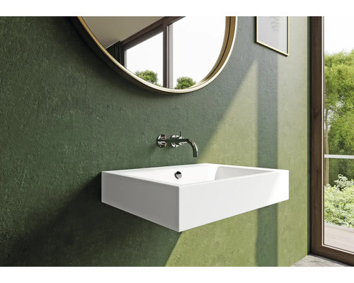 Salle de bain moderne avec lavabo, robinet et miroir rond
