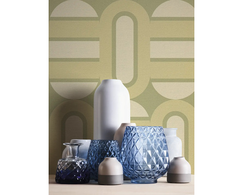 Vases décoratifs sur une surface devant un papier peint à motifs