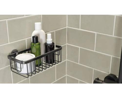 Duschablage aus Metallgitter mit Pflegeprodukten an einer gefliesten Wand