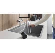 Einbauküchenspüle mit Wasserhahn beim Befüllen einer Trinkflasche