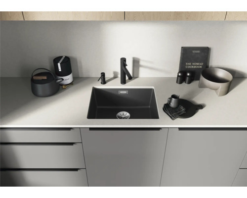 Évier de cuisine avec robinet sur un plan de travail avec divers accessoires