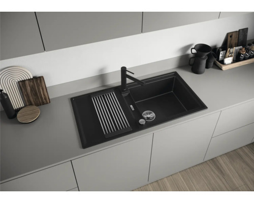 Spüle aus Verbundmaterial mit Abtropffläche und Wasserhahn in einer modernen Küche