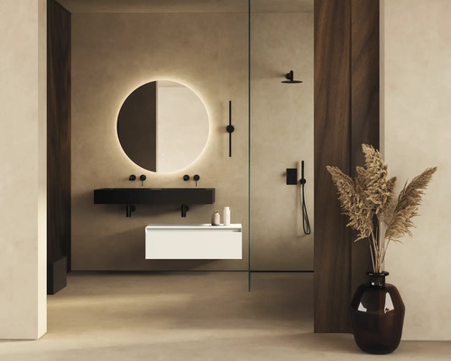 Badezimmer mit runder Spiegelleuchte, schwarzem Waschtisch, weißem Unterschrank und Dusche.