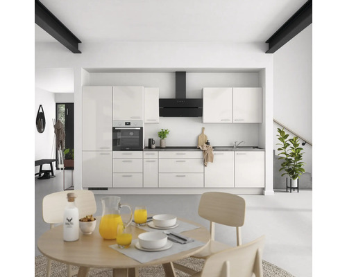 Cuisine claire avec table à manger et chaises dans une pièce meublée moderne.
