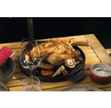 Poulet grillé sur une plaque de cuisson avec des légumes sur une table en bois