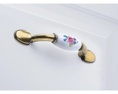 Poignée de meuble en métal et céramique avec motif floral