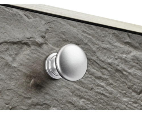 Vue détaillée d''un meuble avec aspect pierre et un bouton de meuble rond