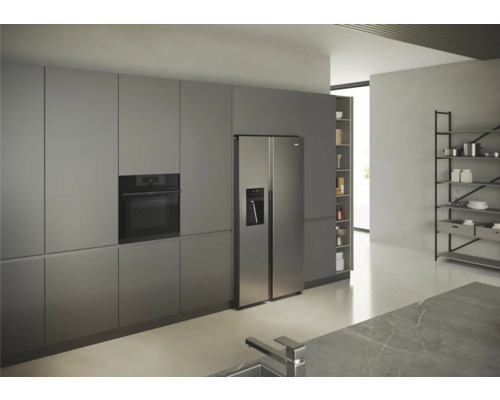 Cuisine moderne avec four intégré et réfrigérateur côte à côte.