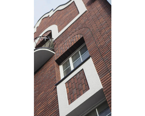 Façade d''un bâtiment avec maçonnerie en briques, fenêtres et balcon