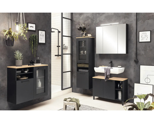 Ensemble de salle de bains moderne avec lavabo, armoire de toilette et meubles bas dans un aspect sombre.