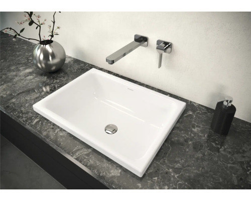 Aufsatzwaschbecken im Badezimmer auf einer Arbeitsplatte mit Armatur und Dekoration