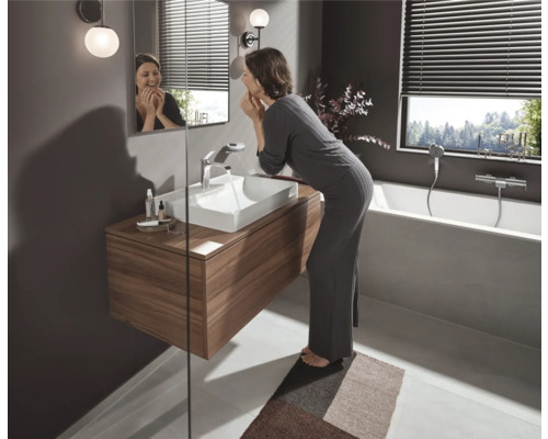 Modernes Badezimmer mit Waschtisch, Spiegel, Badewanne und Rollos für Sichtschutz