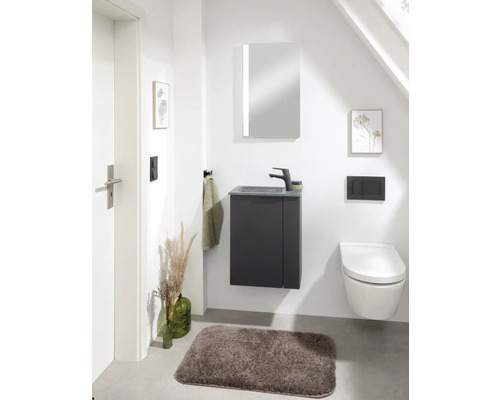 Modernes Badezimmer mit Waschtisch, Spiegelschrank, Toilette und Badteppich