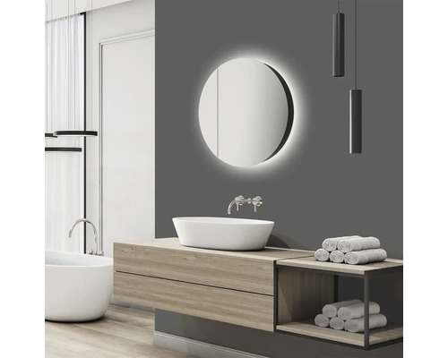 Salle de bains moderne avec armoire de toilette ronde, lavabo et baignoire.