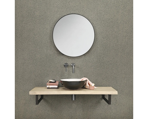 Badezimmer mit rundem Spiegel, Waschtischplatte und Aufsatzwaschbecken