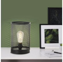 Lampe de table en grillage métallique avec ampoule sur une table