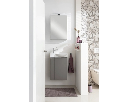 Salle de bain lumineuse avec meuble sous-lavabo, armoire de toilette et WC