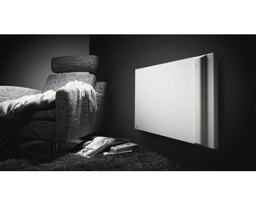 Szene mit einem Heizkörper an der Wand neben einem Sessel, mit Büchern auf dem Teppich