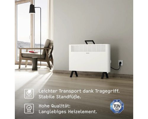 Radiateur convecteur électrique dans un espace de vie avec poignée de transport et label TÜV Süd