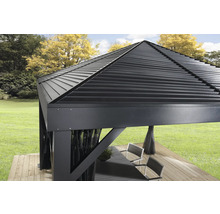 Gros plan d''un pavillon avec un toit en métal sur une terrasse en bois dans un jardin.