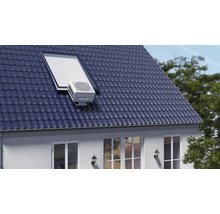 Climatiseur sur le toit d'une maison avec fenêtre de toit