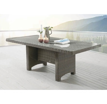 Table de jardin avec plateau en verre et aspect rotin sur une terrasse avec vue sur les montagnes