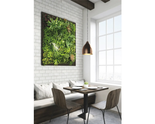 Essbereich mit Pflanzenwand, Tisch und Stühlen vor einem Fenster