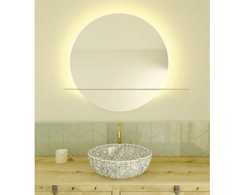 Aménagement de salle de bains avec miroir rond, meuble-lavabo et vasque à poser à motifs floraux