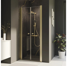Douche à l''italienne avec cadre doré dans une salle de bains.
