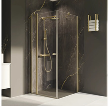 Douche d''angle avec ferrures dorées et porte-serviettes dans la salle de bains