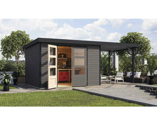 Abri de jardin moderne avec établi et terrasse couverte dans le jardin.