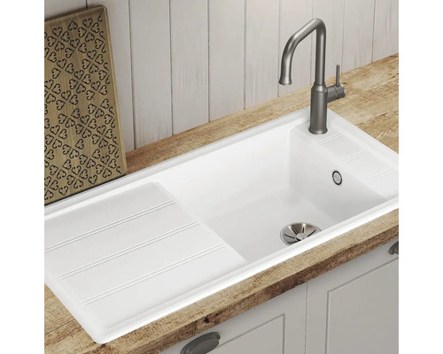 Évier avec égouttoir et robinet dans un environnement de cuisine.