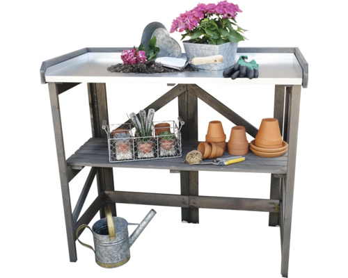 Table de jardin en bois avec plantes, pots et outils de jardinage